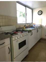Traditional kitchen with granite counters, gas stove, large window in Coronado Bay Panama