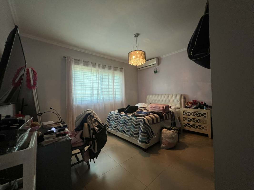 Modern bathroom with glass shower, mosaic tile accents, double sinks Dorado Village Panama