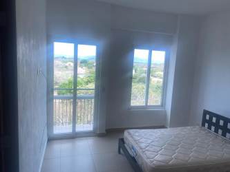 Enclosed balcony or sunroom with kitchenette overlooking ocean and garden PH Punta Barco Village Panama