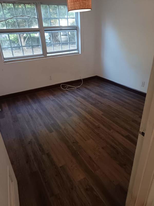 Bedroom with AC unit, large window, laminate floors in Clayton apartment Panama City