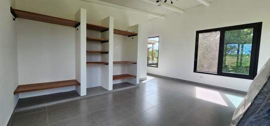 Bedroom with large windows garden view modern finishes in Pedasí tropical residence