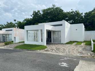 Modern minimalist white villa with driveway garden at Ibiza Beach Residences near Juan Hombrón