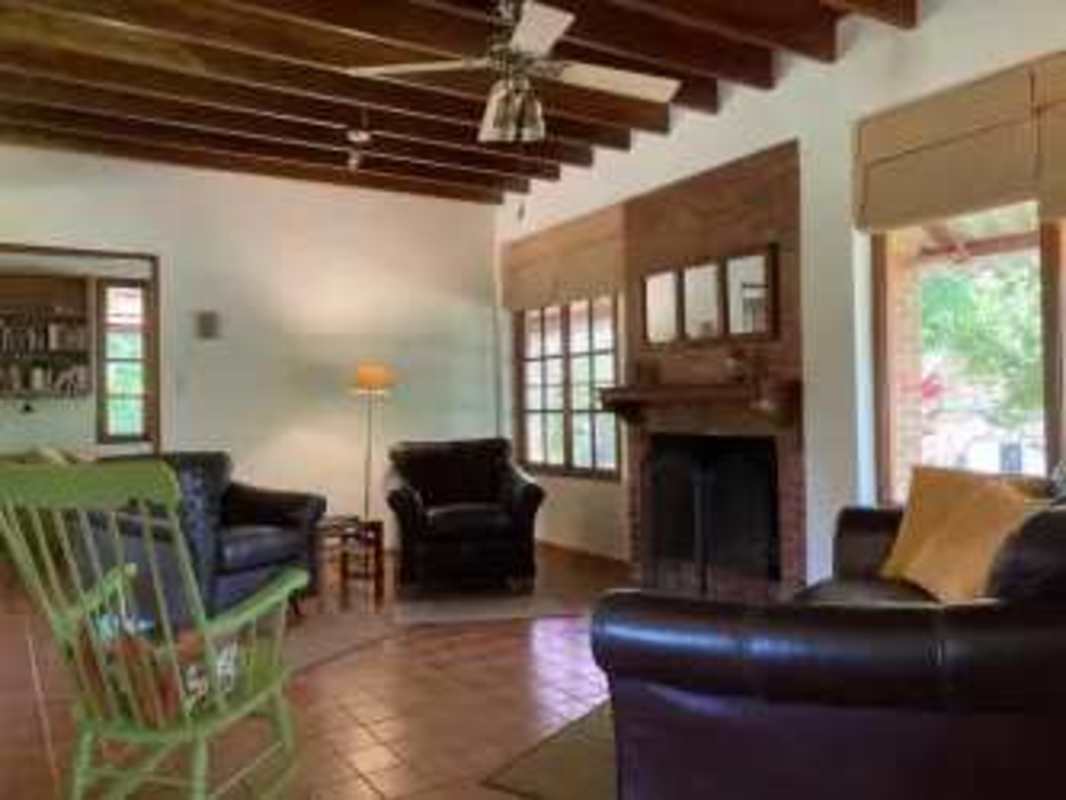 Interior living room with wood windows built-in shelves rustic decor Cerro Azul Panama