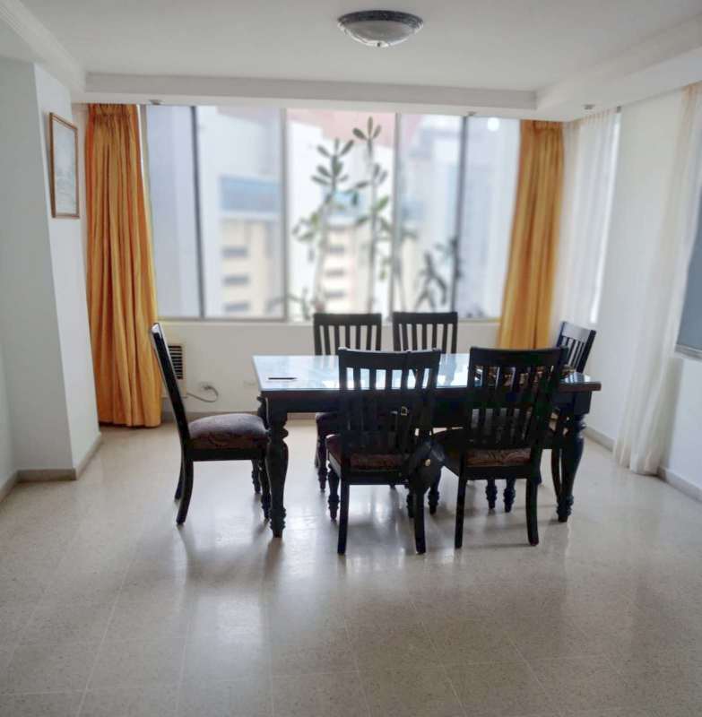 Bright dining area with large window overlooking city skyline in PH Torre Marbella Vista