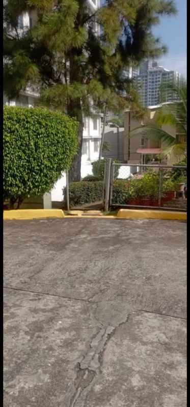 Minimalist bathroom with pedestal sink and tiled walls in El Cangrejo Panama apartment
