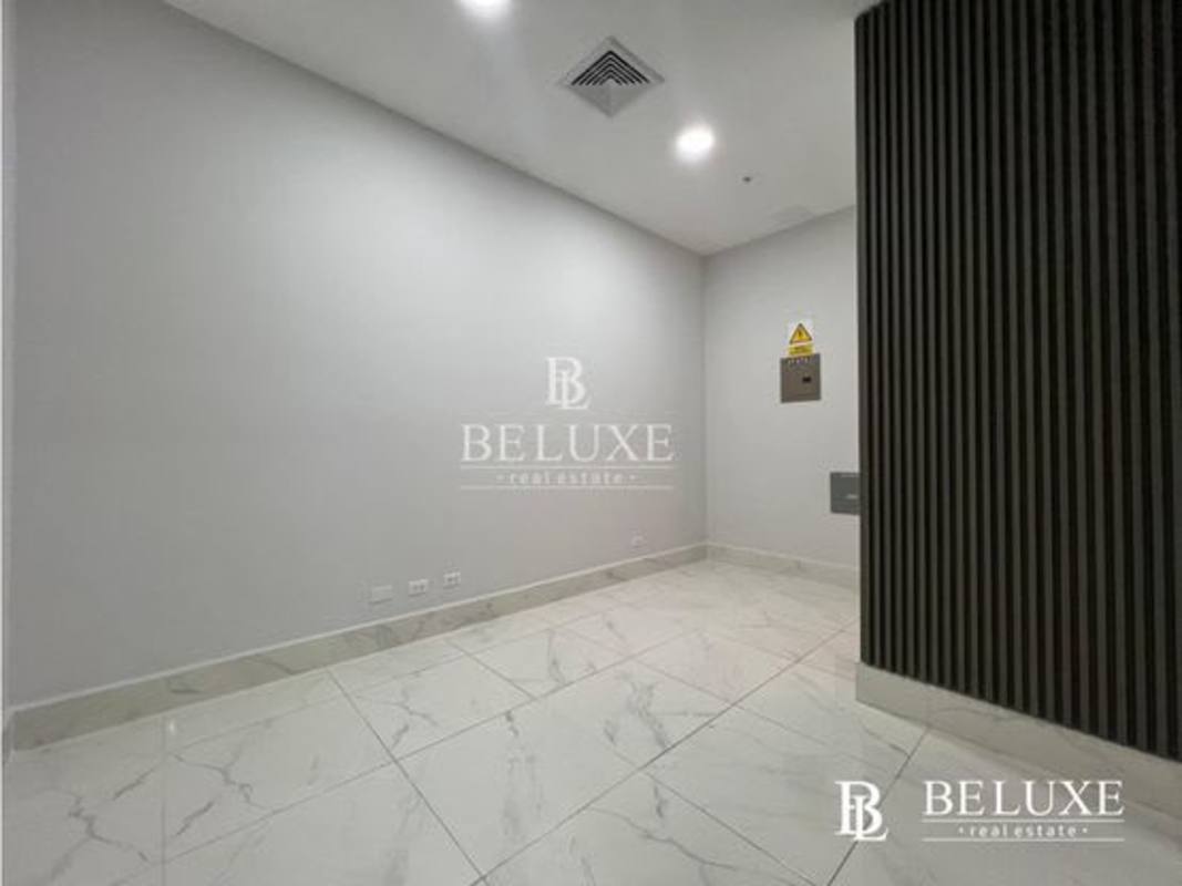 Shared office kitchen with island seating modern lighting at Town Center Costa del Este Panama