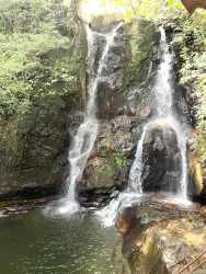Waterfall cascading over rocks with forested surroundings on rural Panama land
