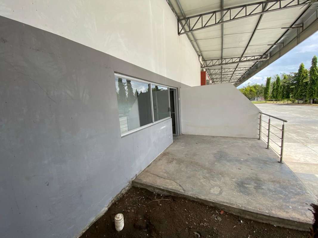 Spacious empty warehouse interior with high ceilings concrete walls and beam structure in Las Mañanitas Panama