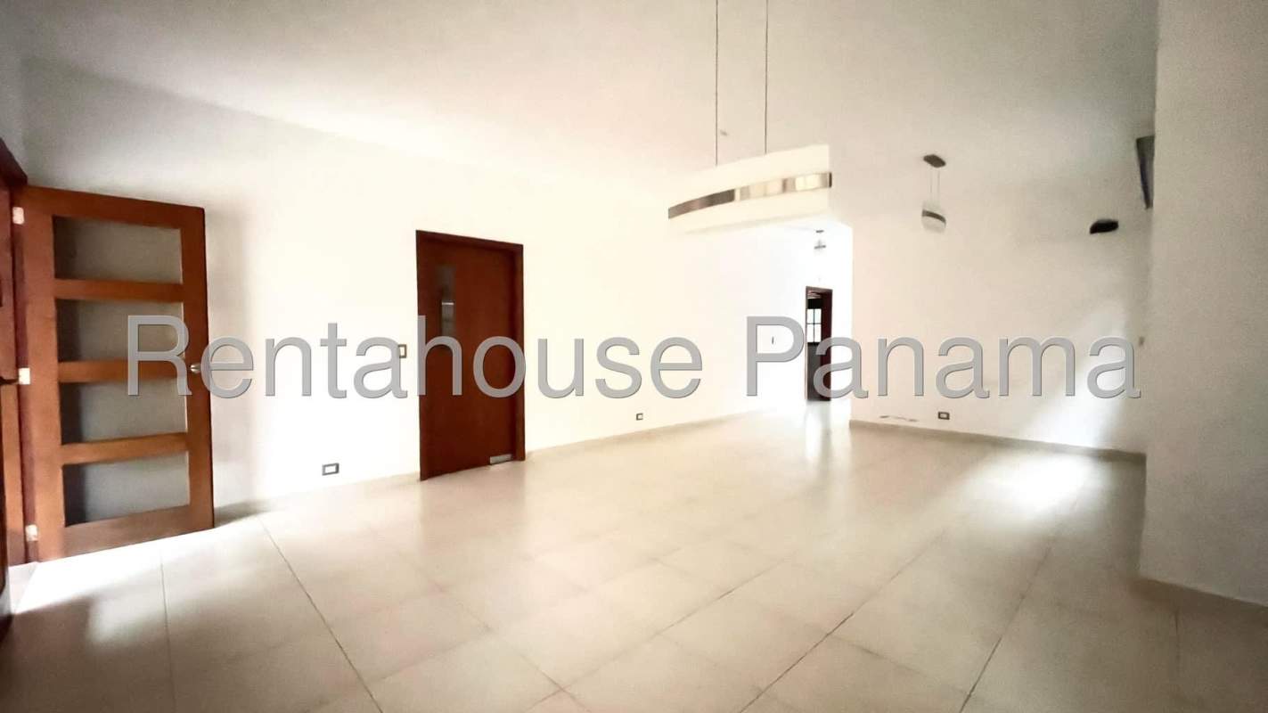 Large bright kitchen with granite counters, wood cabinetry in Costa Sur house