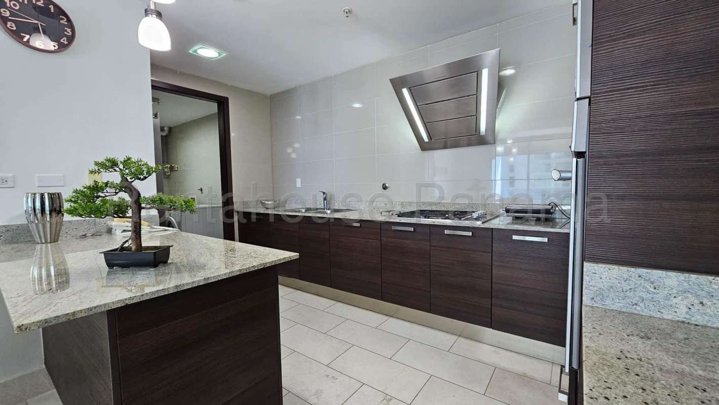 Luxury kitchen dark cabinetry granite counters stainless steel appliances PH Ocean Club Panama City luxury condo