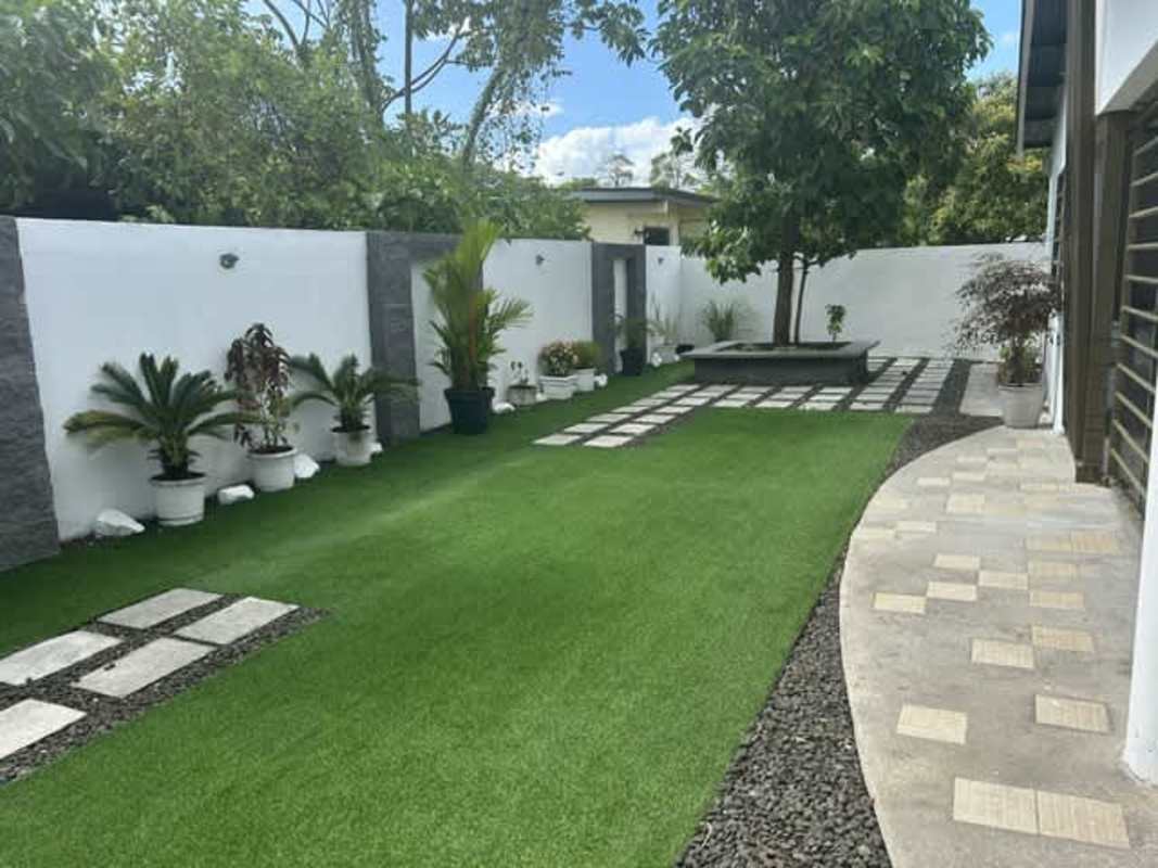 Covered terrace patio with hammock, seating area in Chanis single-family house for sale Panama