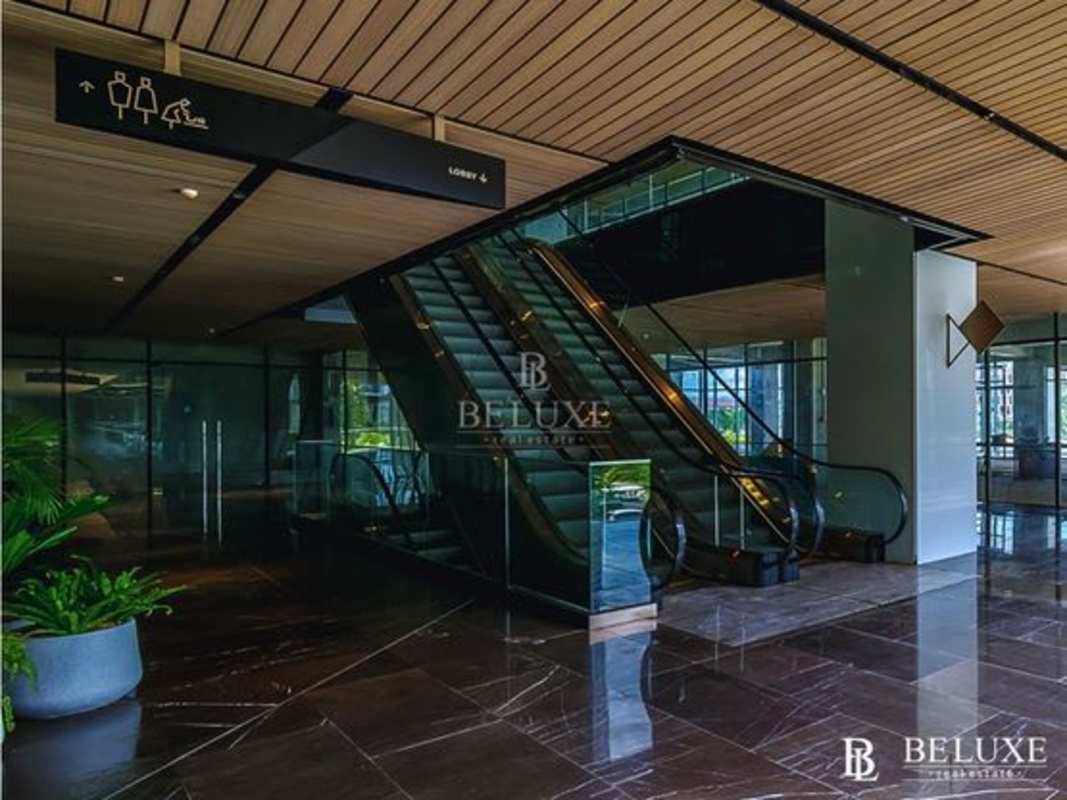 Elegant commercial lobby with marble floors, escalator and glass walls in Costa del Este