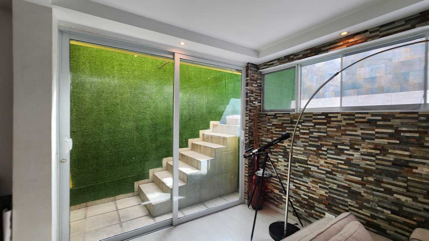 Private outdoor terrace with green wall and seating Limajo Panama house