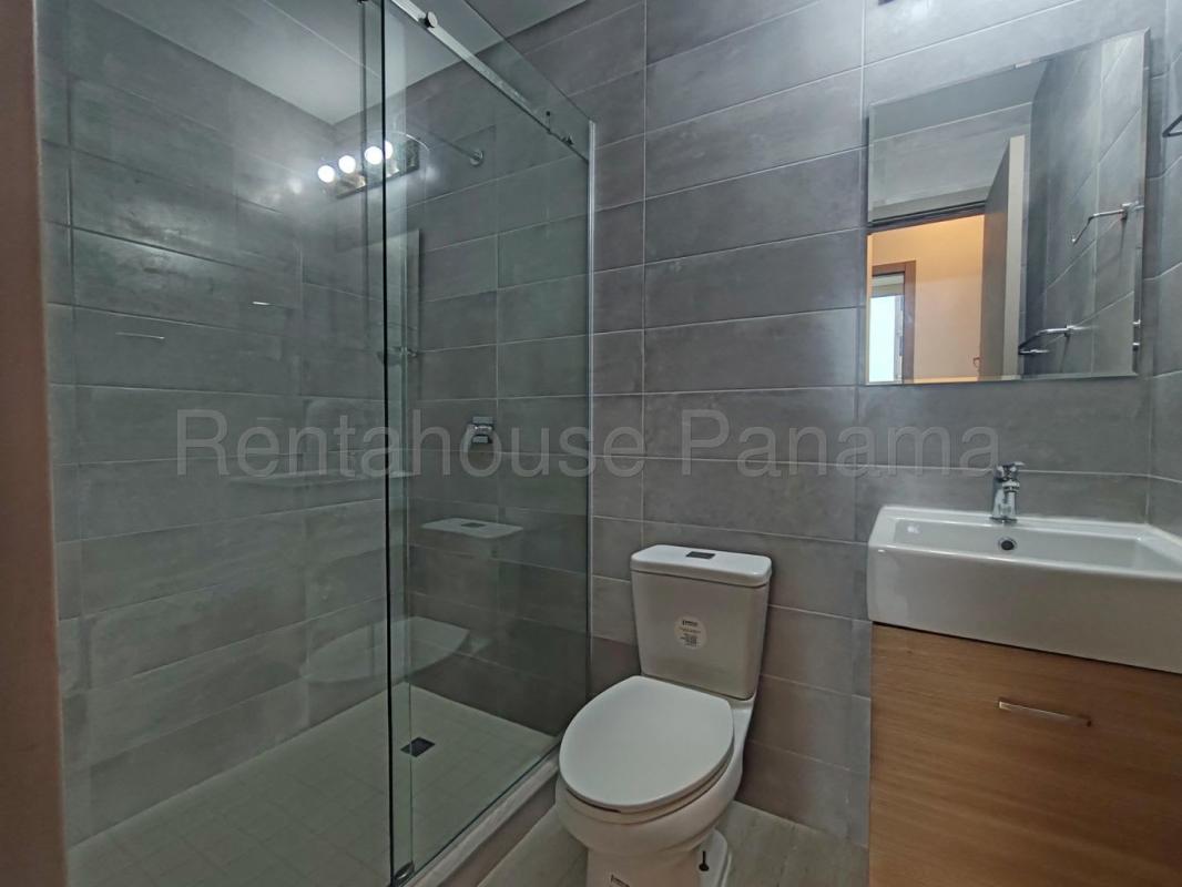 Bedroom with large window overlooking city in PH Urbana Obarrio Panama