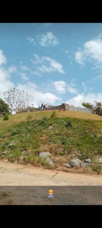 Elevated plot with grassy hill and unfinished building in Las Vistas Cerro Azul Panama