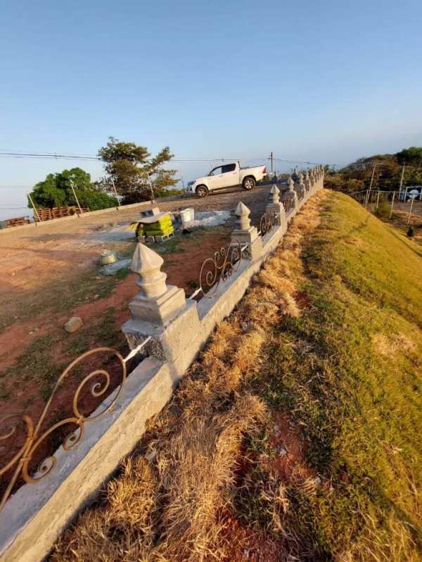 Iron rail atop decorative stone walls on rural hill Cerro Azul Panama