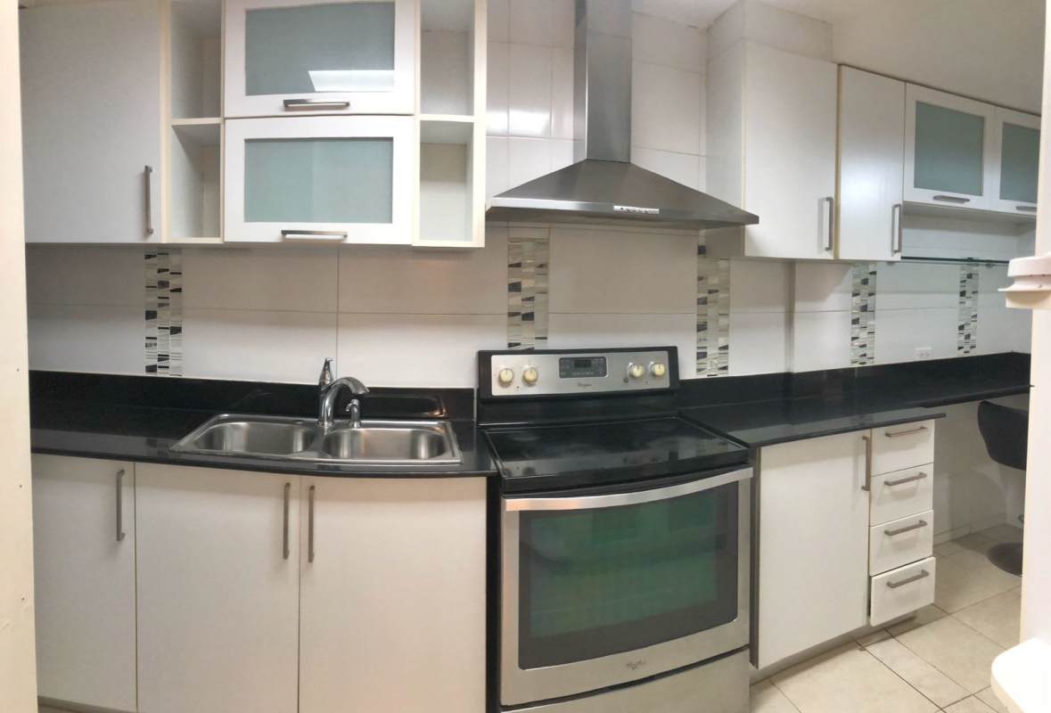 Living room with stone accent wall, tiled floor, AC, spacious design PH Condado del Rey