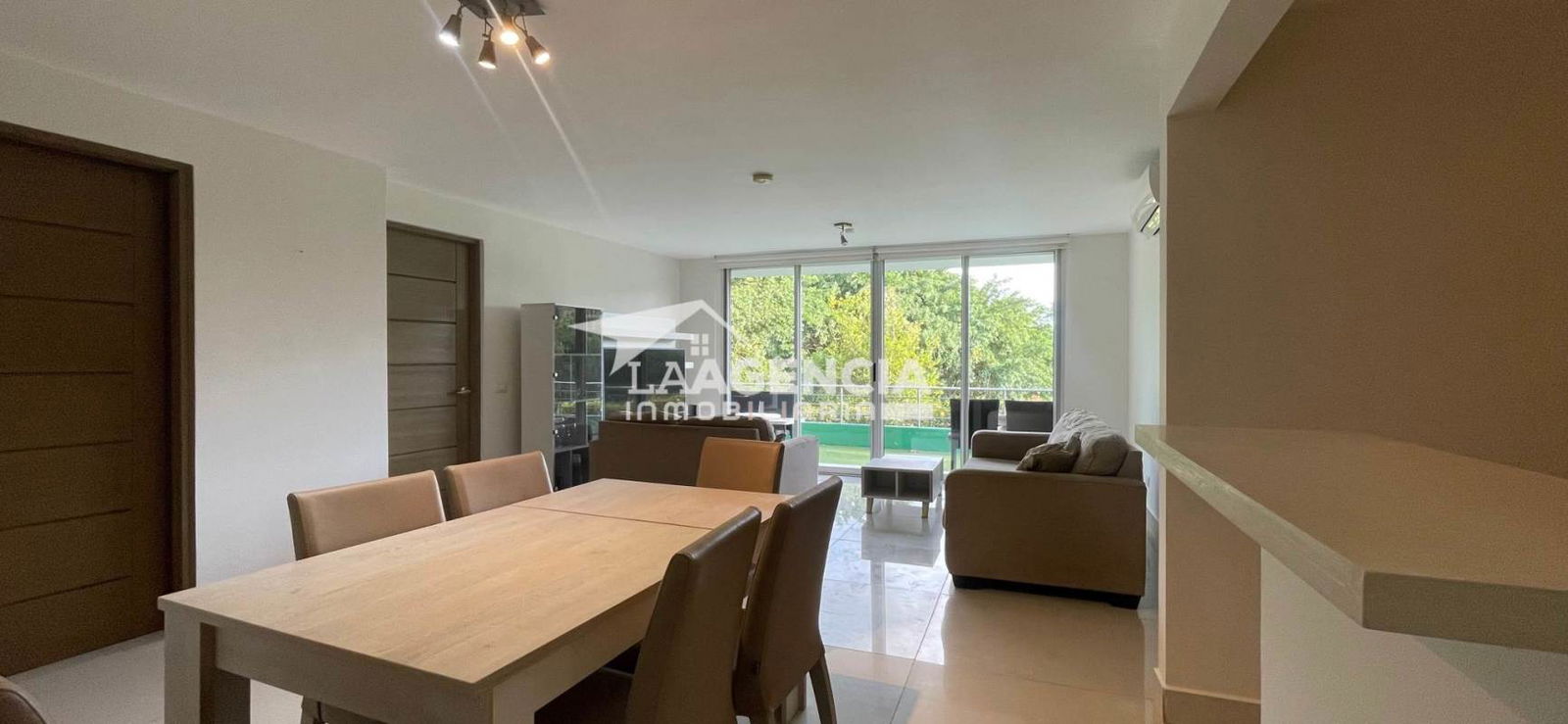 Contemporary living and dining space with terrace access and garden views Clayton Hill Residences Panama