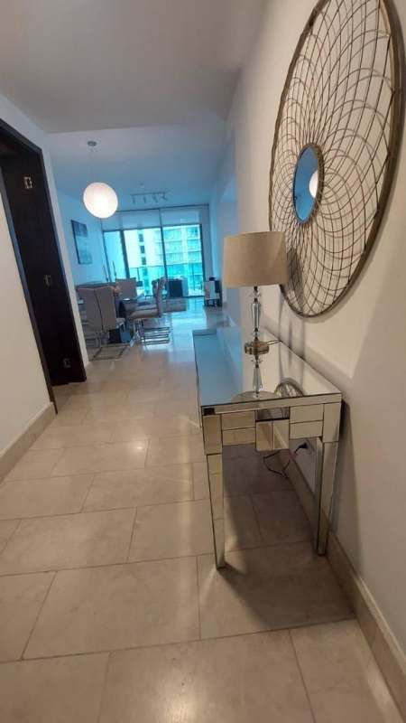 Dining space with glass table and panoramic ocean-city views in PH Grand Tower Punta Pacifica