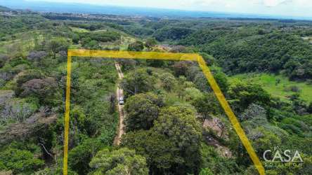Rural undeveloped land in Palmira Boquete with mountain backdrop and dirt access road