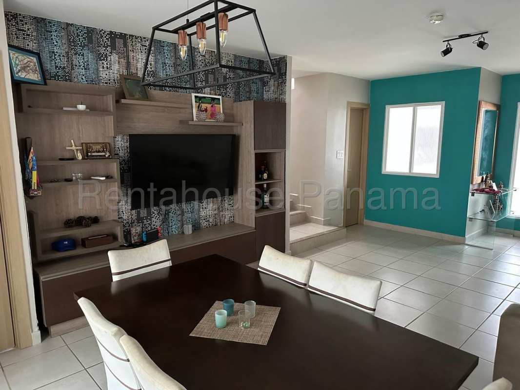 Spacious living dining room with accent wall, wall-mounted entertainment center, neutral floor tiles in PH Victoria Brisas del Golf Panama