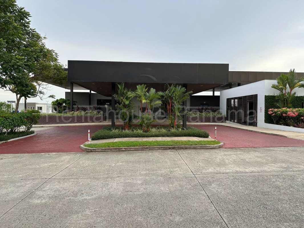 Modern two-story townhouse with carport, contemporary facade, small garden in PH Victoria Brisas del Golf Panama