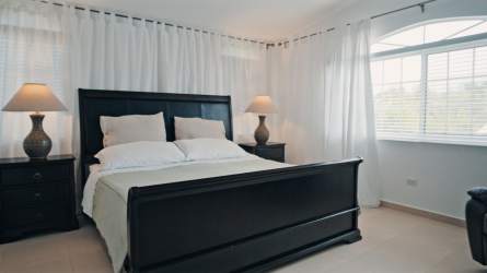 Master bedroom with ensuite bath air conditioning and garden views in Coronado Panama house