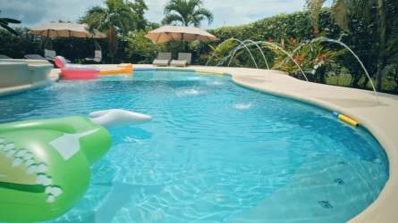 Outdoor terrace overlooking garden and pool in luxurious Coronado Panama property