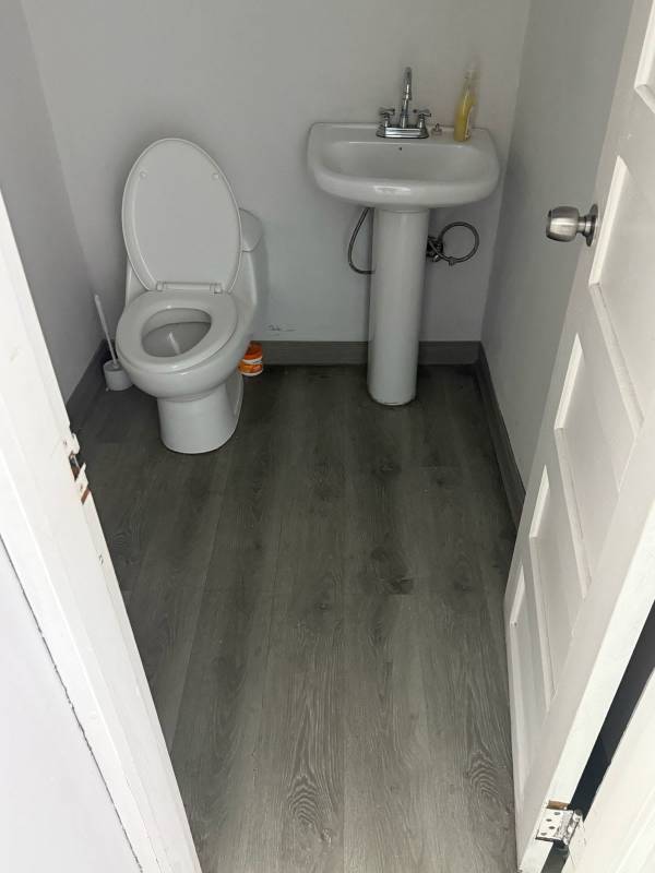 Simple restroom with pedestal sink and toilet in Juan Diaz industrial property Panama