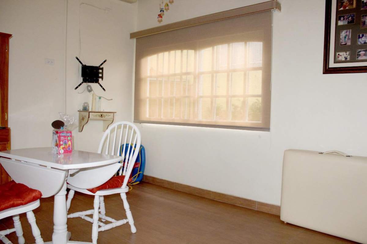 Bright dining area with white table, window blinds Betania Panama City