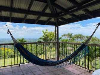 Outdoor terrace with hammock and lush mountain view, Santa Rita Colón estate