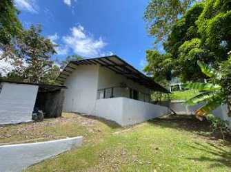 White mountain house on slope with greenery, Santa Rita Colón