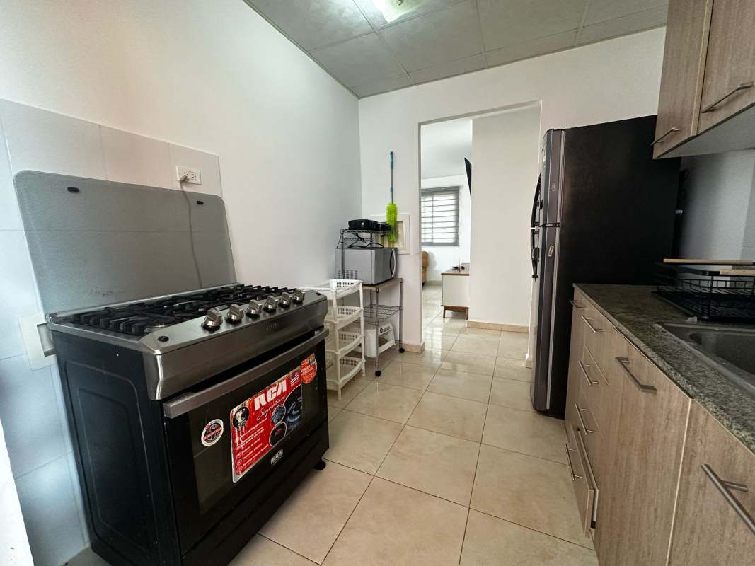 Kitchen with granite counters, gas stove, appliances PH Vallejo house Panama City