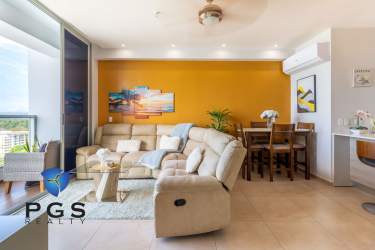 Modern living room opens to balcony with beach and ocean view at Royal Palm Gorgona Panama