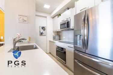 Modern furnished kitchen with granite countertops at Royal Palm beach condo in Panama