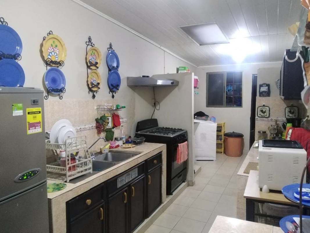 Warm living room with beige sofa curtains wooden furniture Cerro Viento Panama