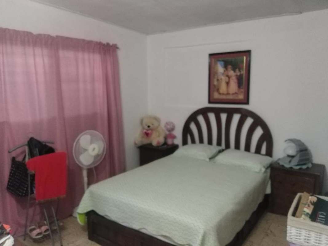 Traditional bedroom double bed pink curtains stuffed toys wall decor Cerro Viento Panama City