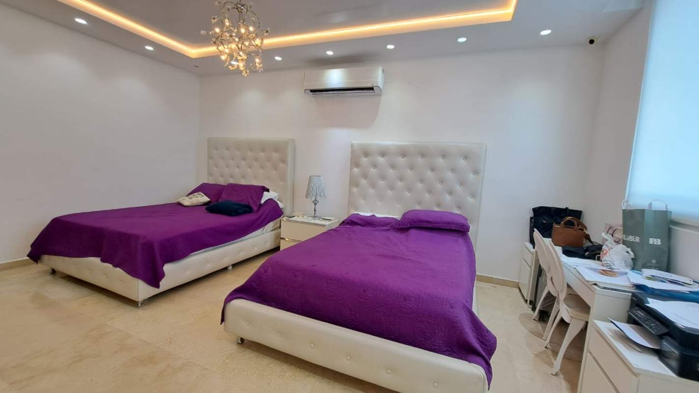 Spacious master bedroom with ocean views, marble floors, chandelier, luxury decor in PH Vista Sol Paitilla