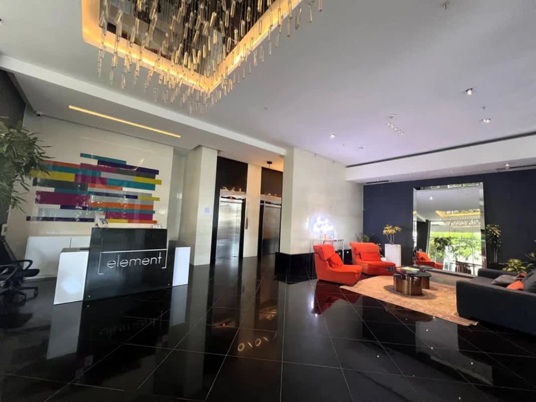 Modern infinity pool with ocean backdrop and sun deck at PH Element