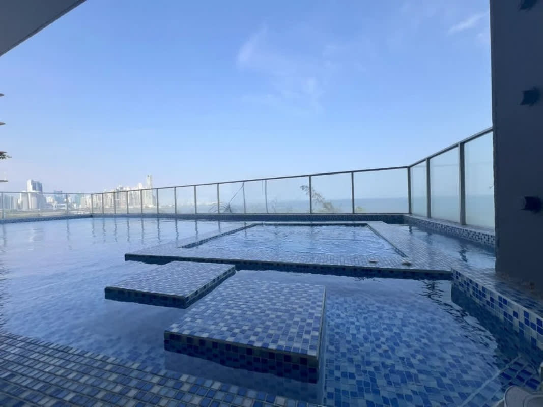 Infinity pool with glass railing and breathtaking ocean views at PH Element