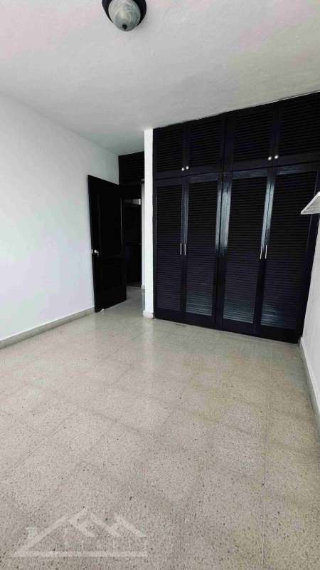Sunlit master bedroom featuring large windows and bay view in Punta Paitilla apartment