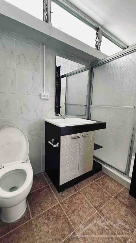 Contemporary bathroom with marble countertop vanity and walk-in shower in PH Paitilla Residences