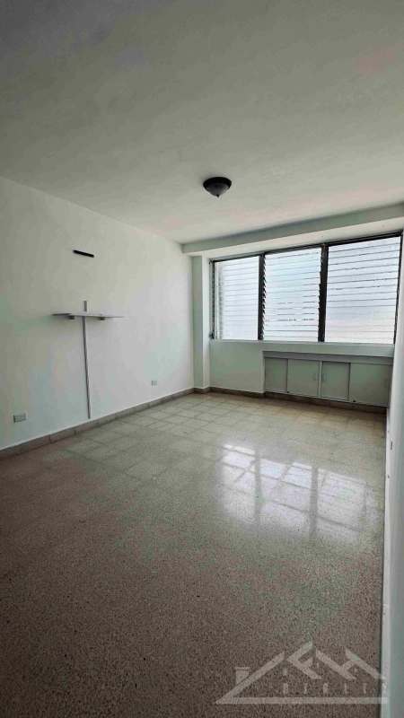 Bright second bedroom with built-in closet and panoramic windows in PH Paitilla Residences