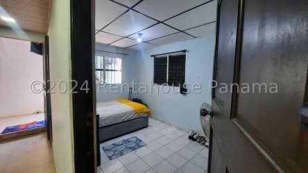 Bedroom with ceramic tile floor and secure window bars in affordable Panama house for sale