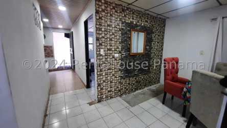 Dining area with modern stone accent wall and tiled floors in affordable Panama Oeste mixed-use house