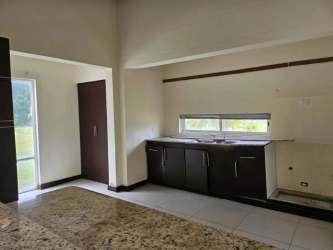 Spacious kitchen with granite countertops, dark cabinetry, large window at Villas Hotel Royal Decameron Rio Hato