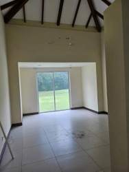 Modern living space with large windows, vaulted ceiling, and views of garden Royal Decameron Rio Hato