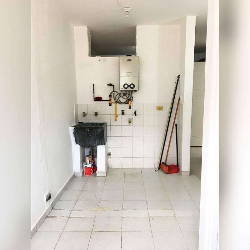 Laundry area with utility sink and water heater PH D'LIGHT San Francisco Panama