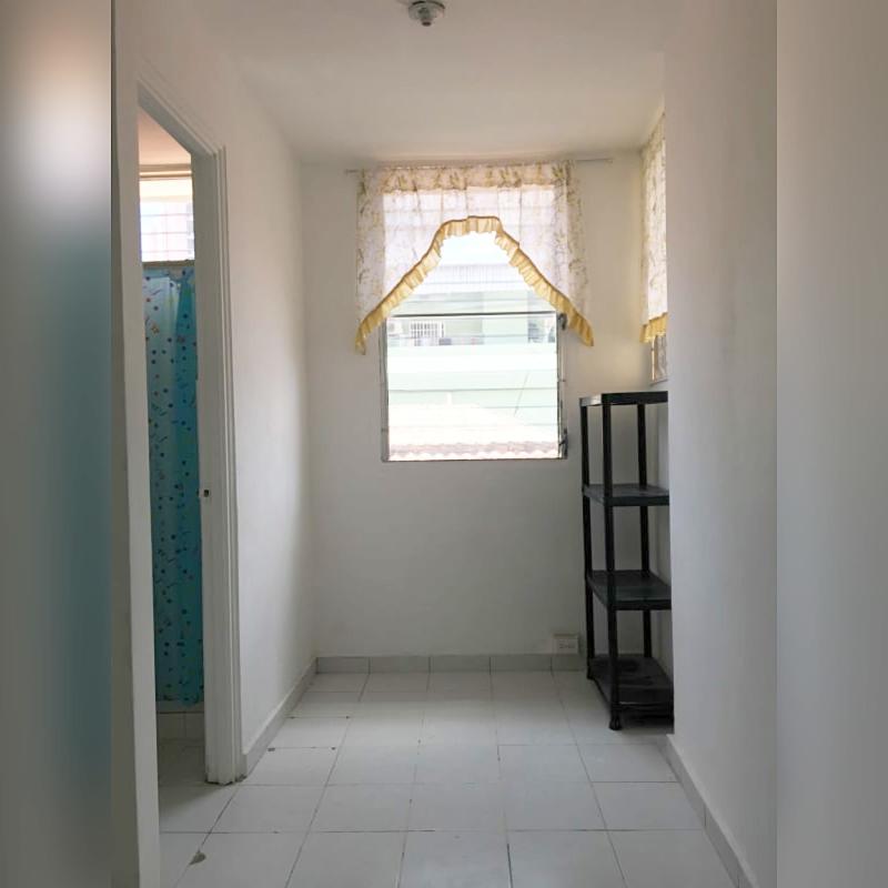 Simple hallway with tiled floor, windows and bath access at PH D'LIGHT Panama City