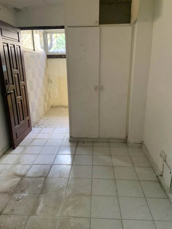 Basic kitchen with cabinets and tiled backsplash in bank-owned apartment Bella Vista Panama